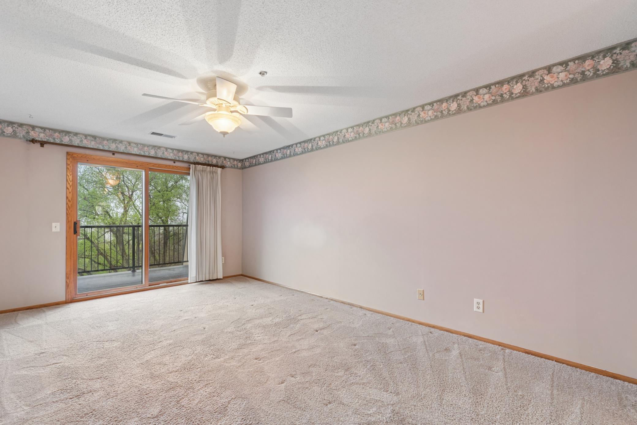 Experience the ultimate luxury of silence in this spacious bedroom featuring triple-pane glass doors.