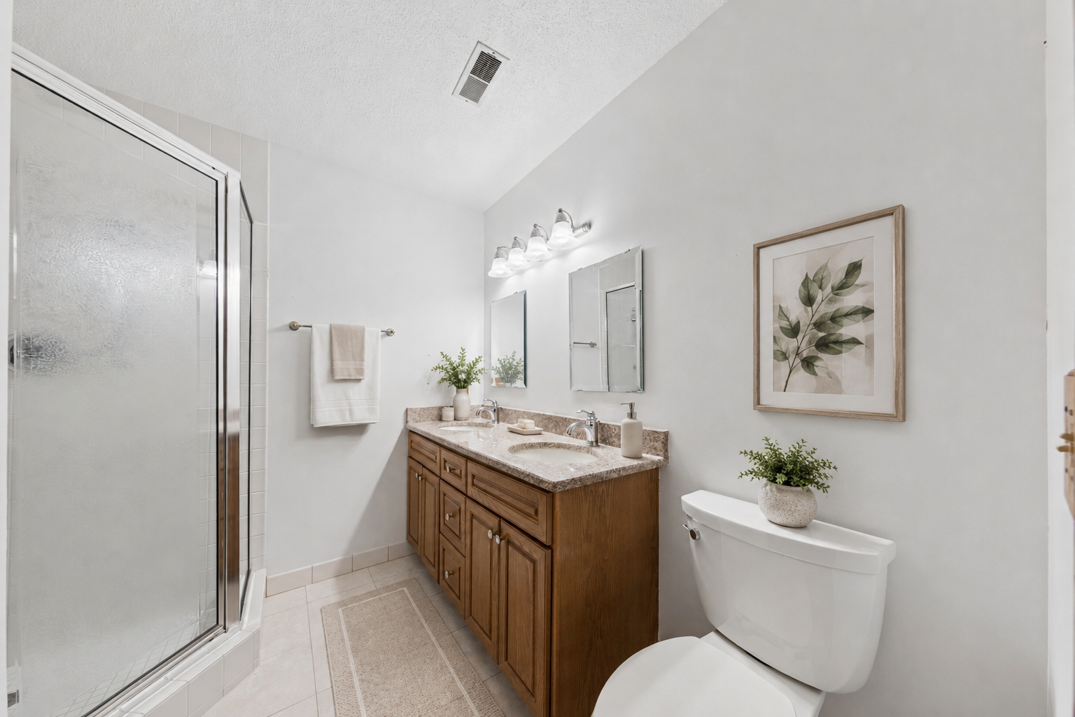 Your private en-suite featuring a double vanity and easy-to-maintain walk-in shower. (virtually staged)