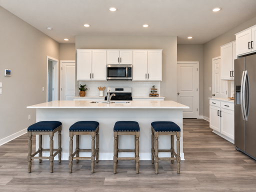Bright and inviting kitchen featuring a large center island with seating, quartz countertops, and stylish cabinetry.