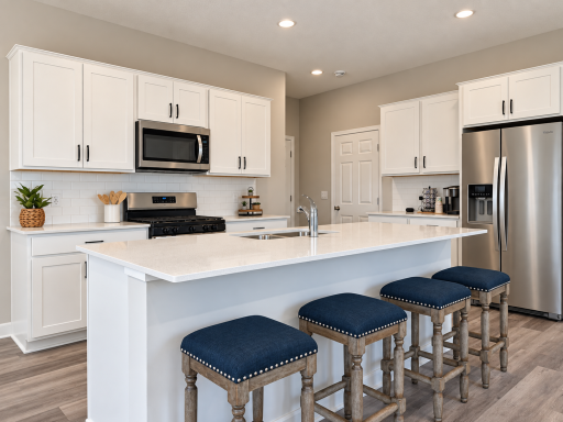 The impressive 7-foot center island provides ample prep space, seating for four, and serves as the heart of this home.