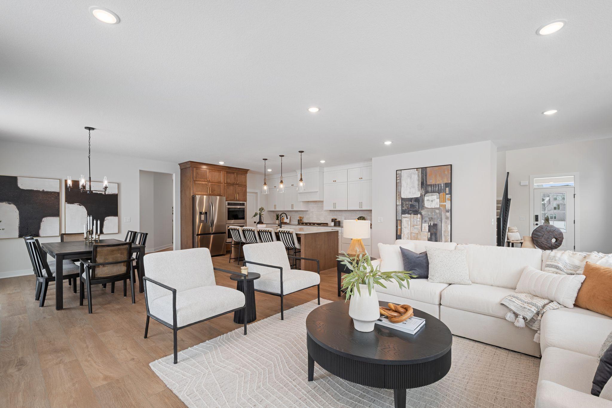 Living room with stone gas fireplace in an open-concept main floor
