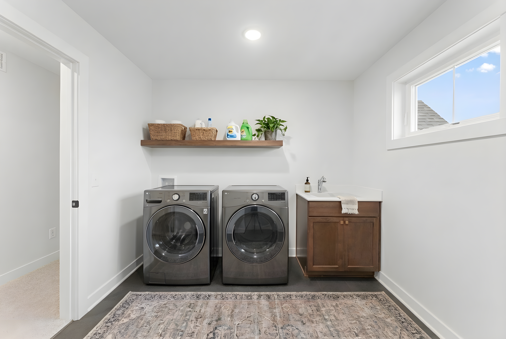 HUGE upper level laundry room with cabinet and deep sink *Photo is virtually staged, washer/dryer not included