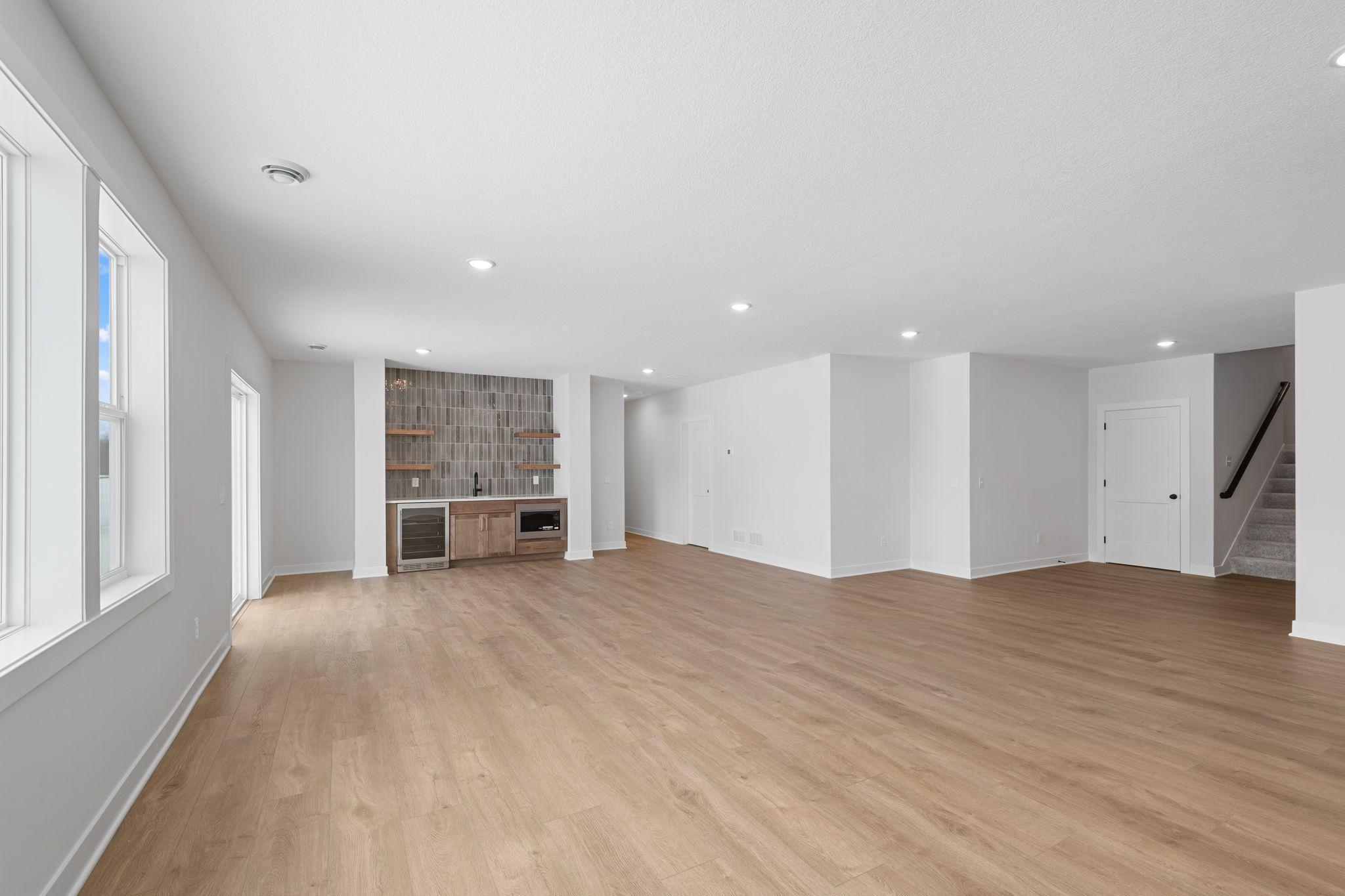 Lower level family room with wet bar and LVP flooring