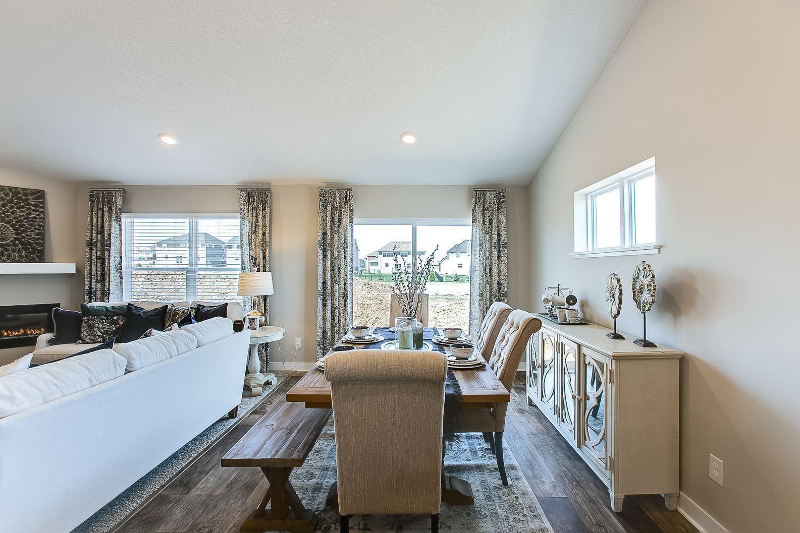 Bright light streams through the patio doors into the dining space. Photos of model home. Colors and options may vary. Ask Sales Agent for details.