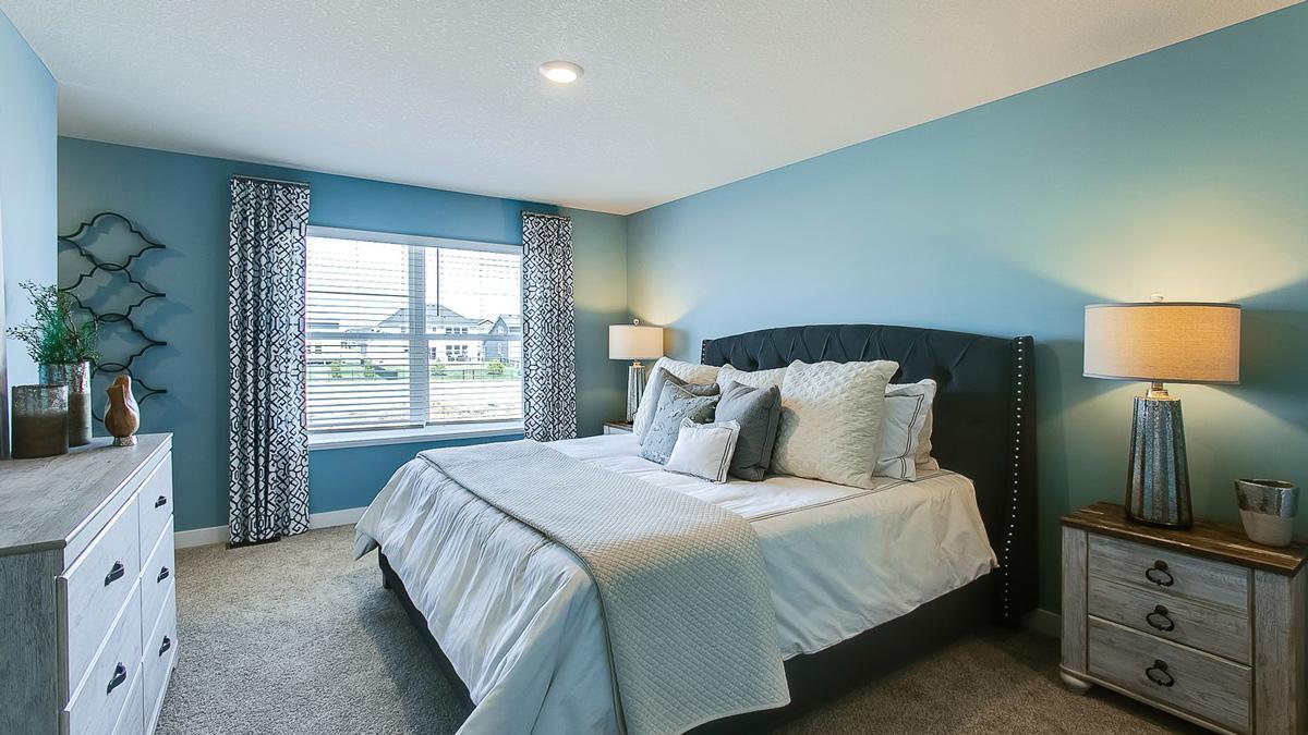 An oasis of its own, the primary suite offers the perfect escape. There's immediate access to a private bathroom that features dual sinks and a large shower. Photo is of model home. Colors and options may vary. Ask Sales Agent for details.