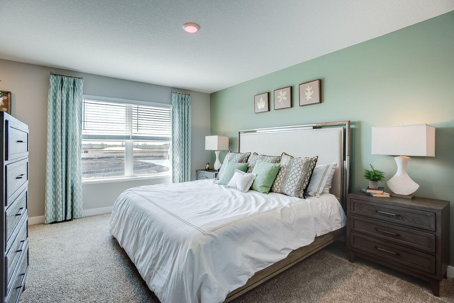 The very generous primary bedroom has plenty of space to fit your dream furniture set. Bedroom fits king-size furniture. Photo of Model Home. Options and colors may vary. Ask Sales Agent for details.