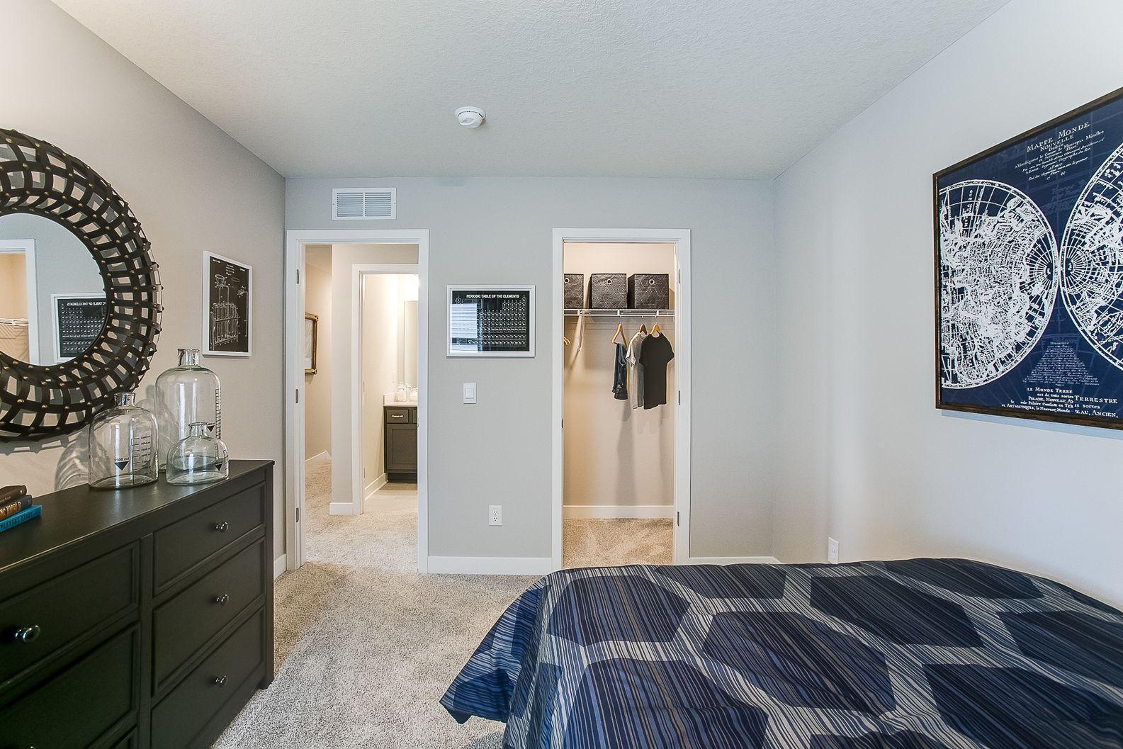 Another upper-level bedroom with abundant space and a walk-in closet! Photo of Model Home. Options and colors may vary. Ask Sales Agent for details.