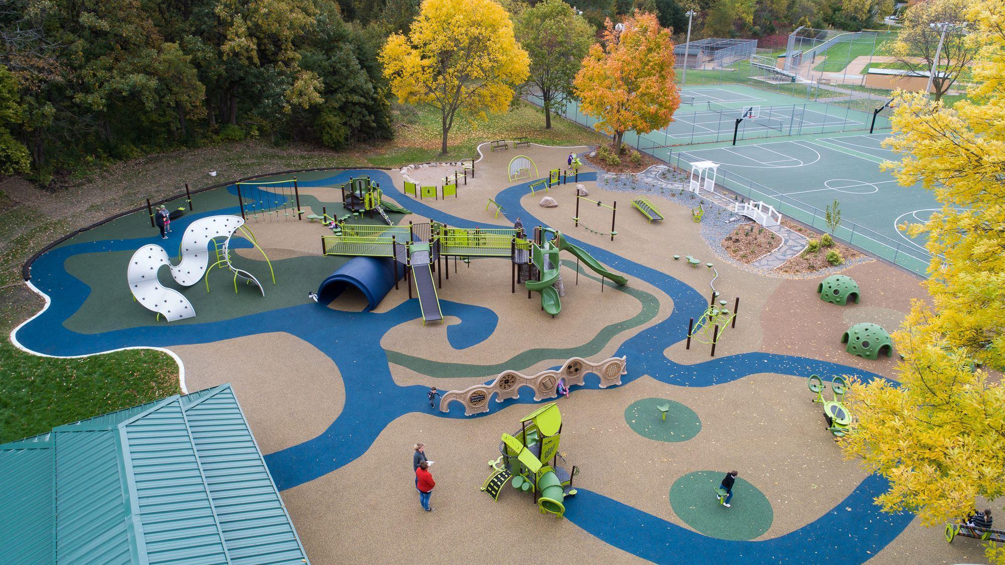 In addition to the 23,000 square foot park, Woodridge Park features paved and natural trails, a pond, baseball/softball fields, an ice skating rink, a sand volleyball court, tennis and basketball courts, and a sledding hill.