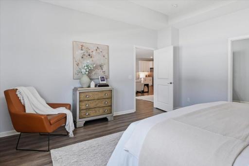 The spacious main level primary bedroom has an ensuite bath and box vault ceiling.
