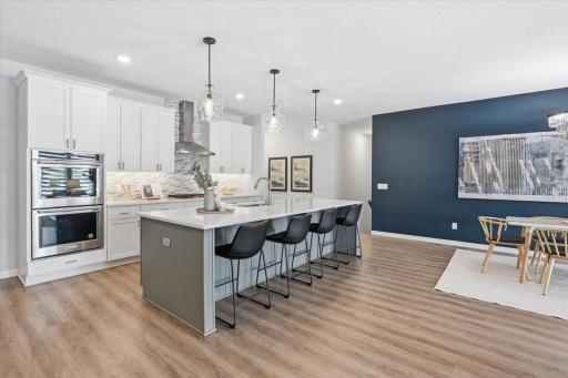 Stainless appliances plus a huge island with quartz countertops.