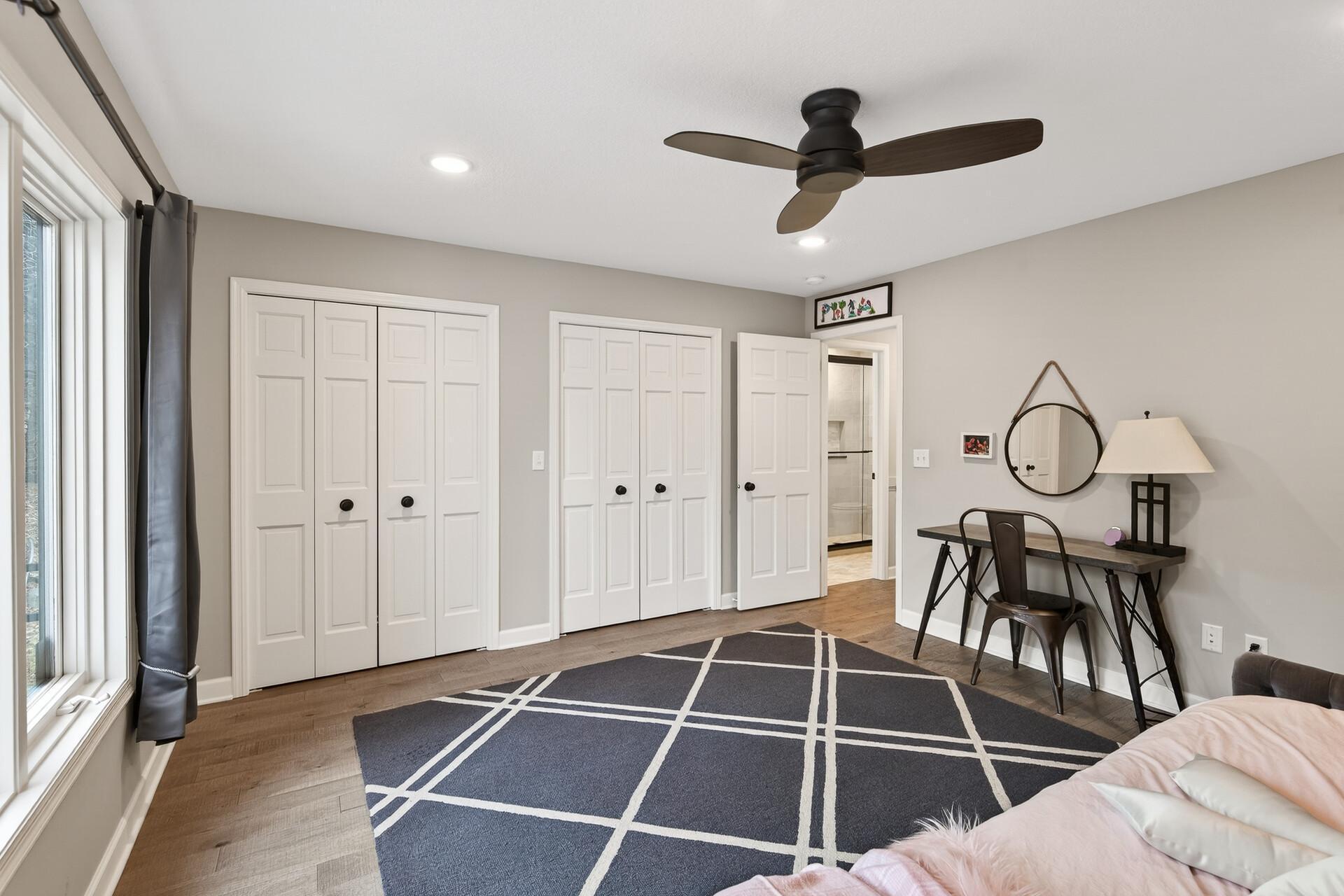 Maximize organization with two separate closets in this bedroom.