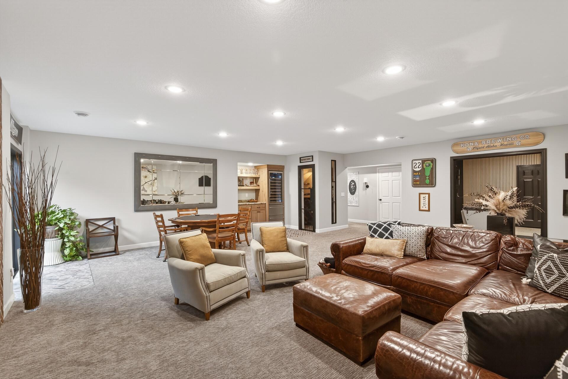 The finished lower level opens into an expansive family room, offering the perfect footprint for a media lounge or game night.