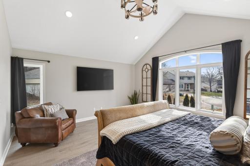 Wake up to peaceful cul-de-sac views through oversized windows that bathe the primary suite in natural light.