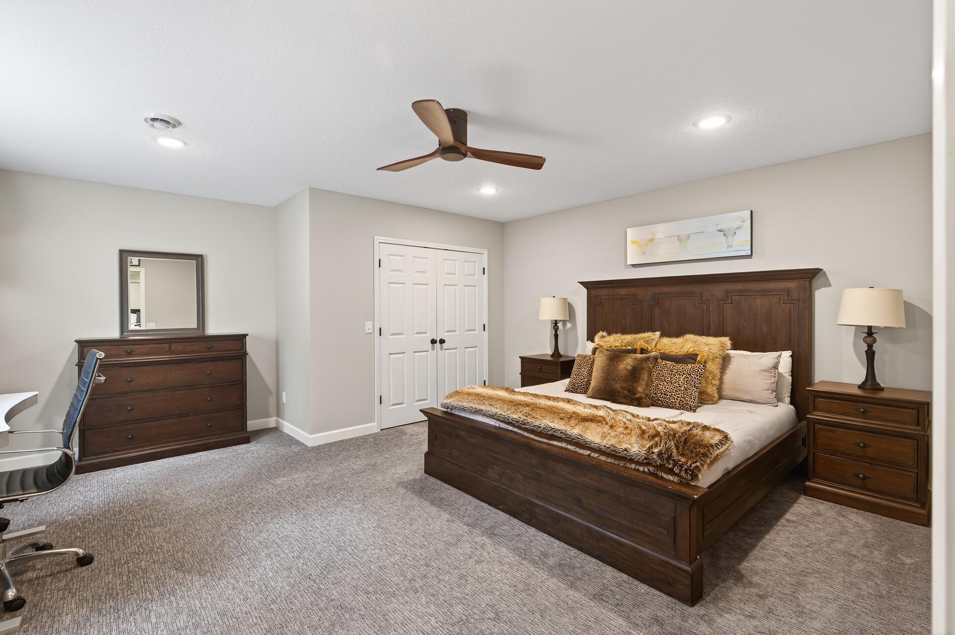 This large bedroom offers not only integrated lighting but natural light and a spacious closet.