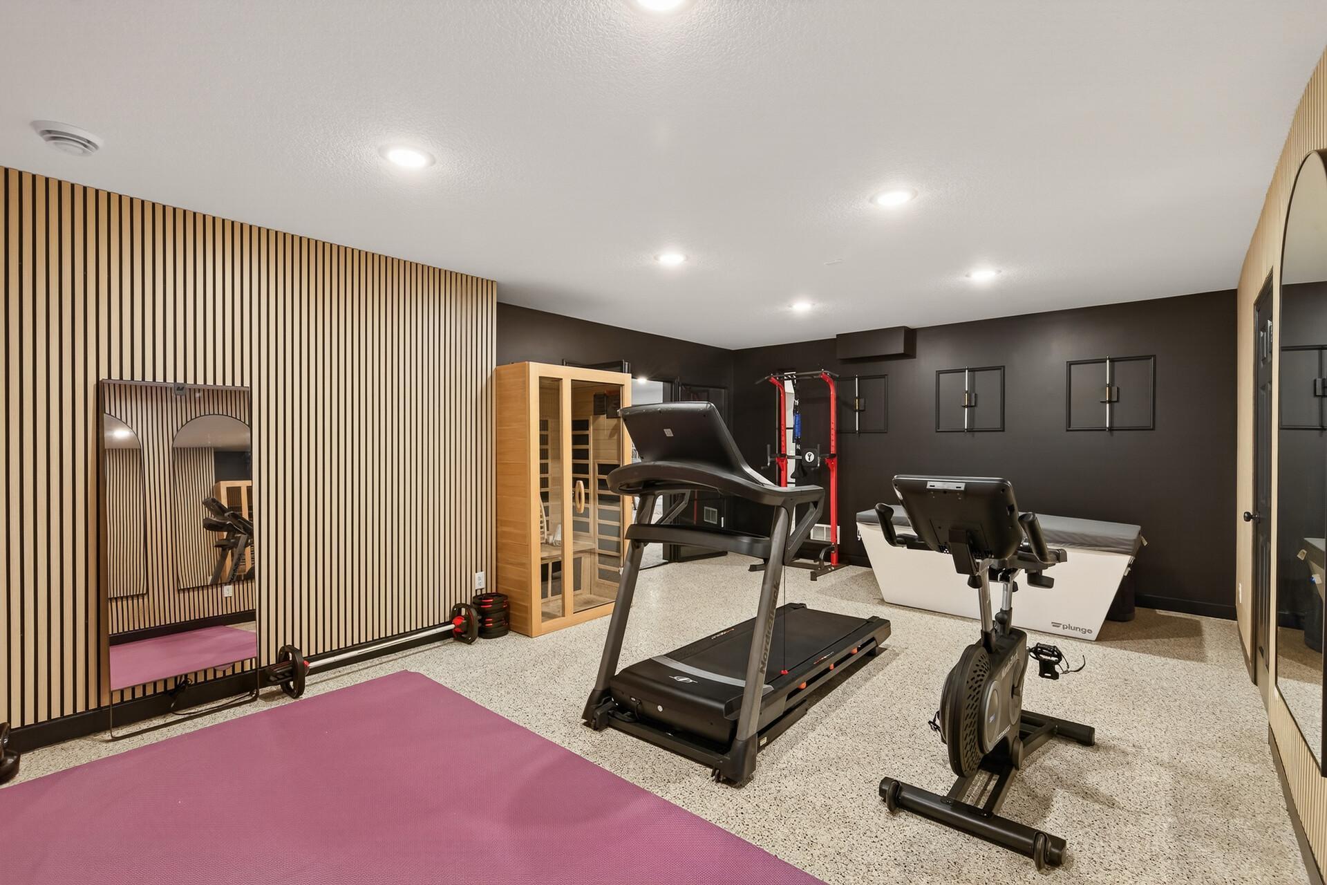 The generous scale of the home gym provides ample room for all your machines and free weights, anchored by a sleek, built-in sauna.