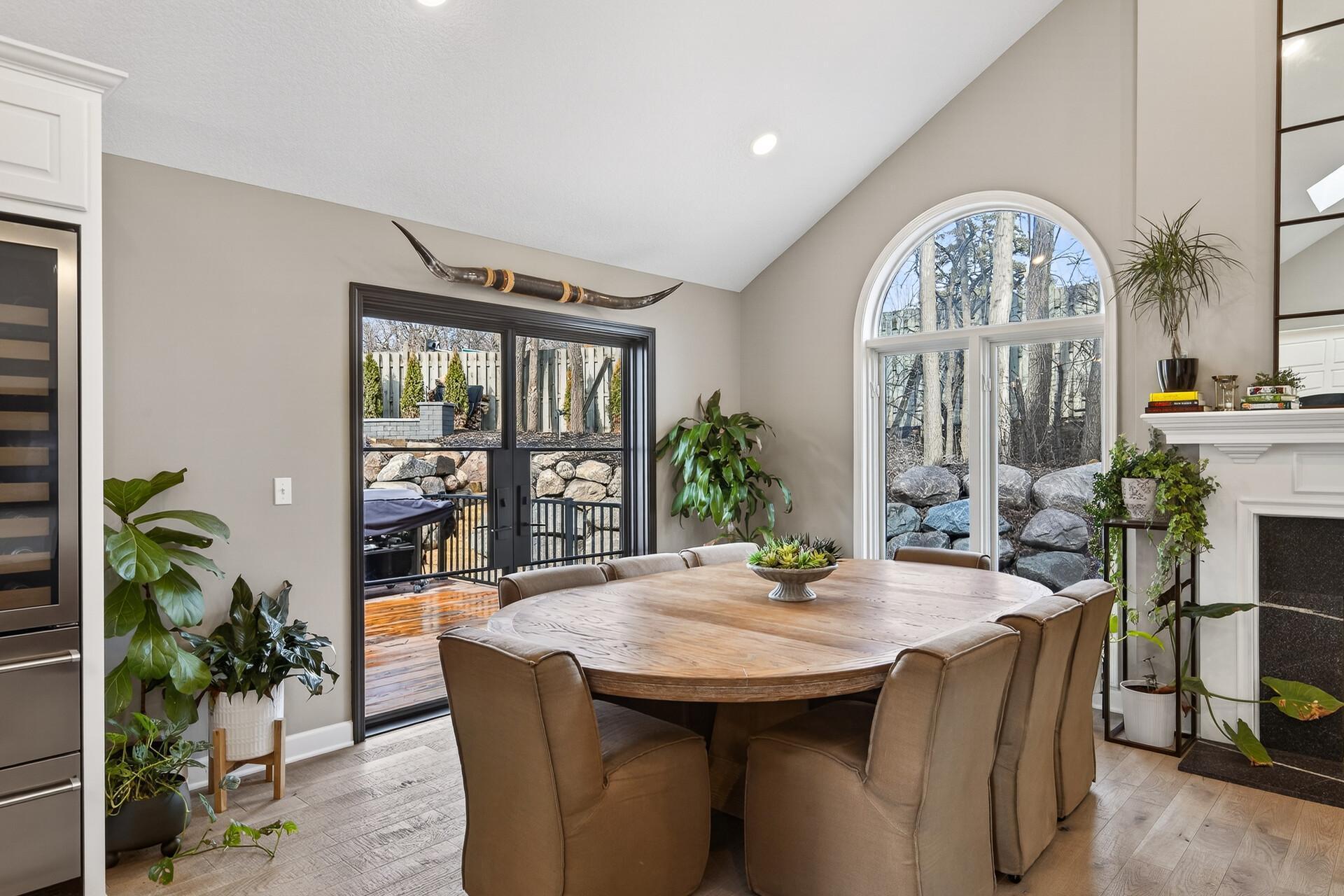 The sun-drenched dining area features seamless patio access and views of the private back yard.