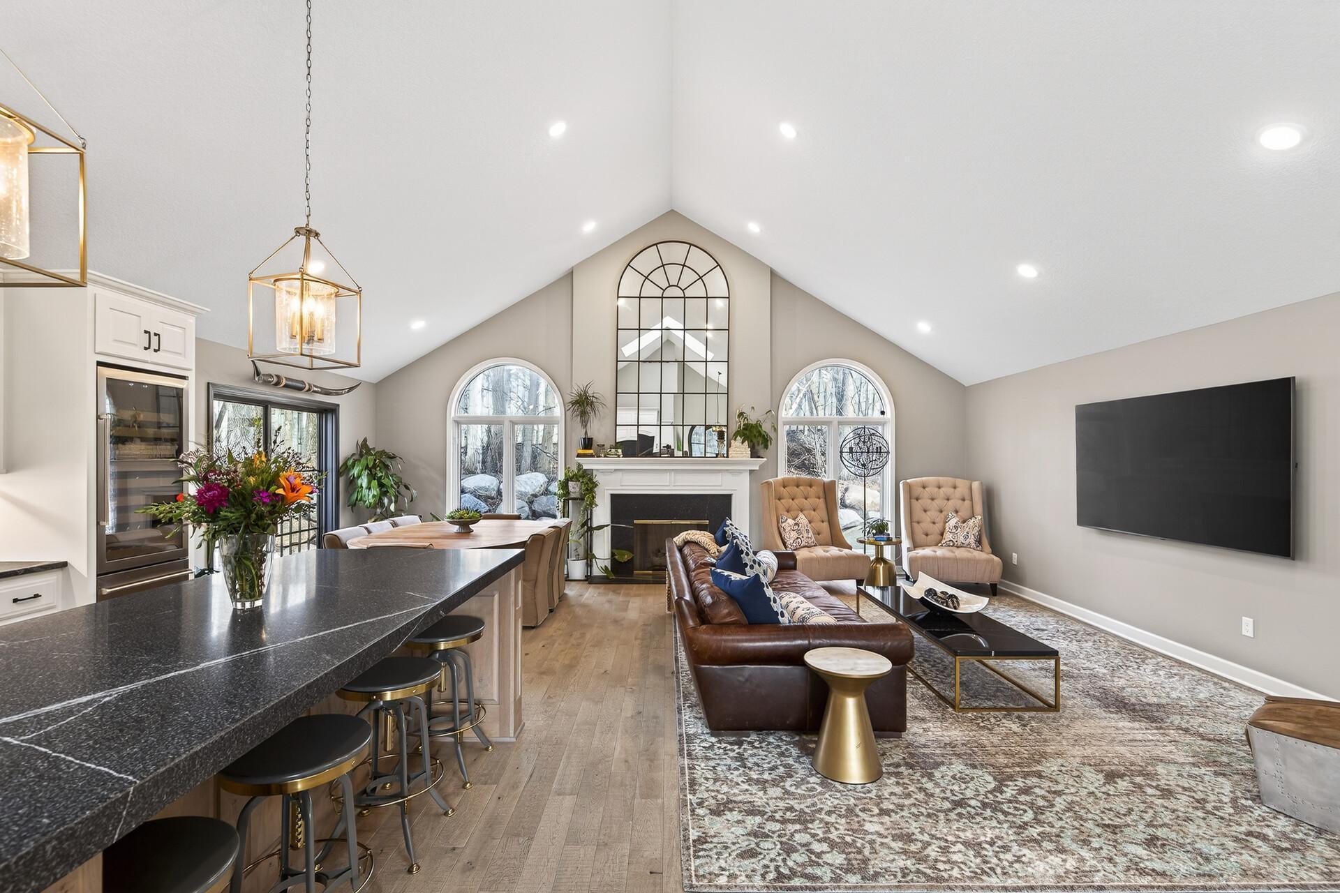 The grand arched windows and patio door offer a picturesque gateway to your own private Edina sanctuary.