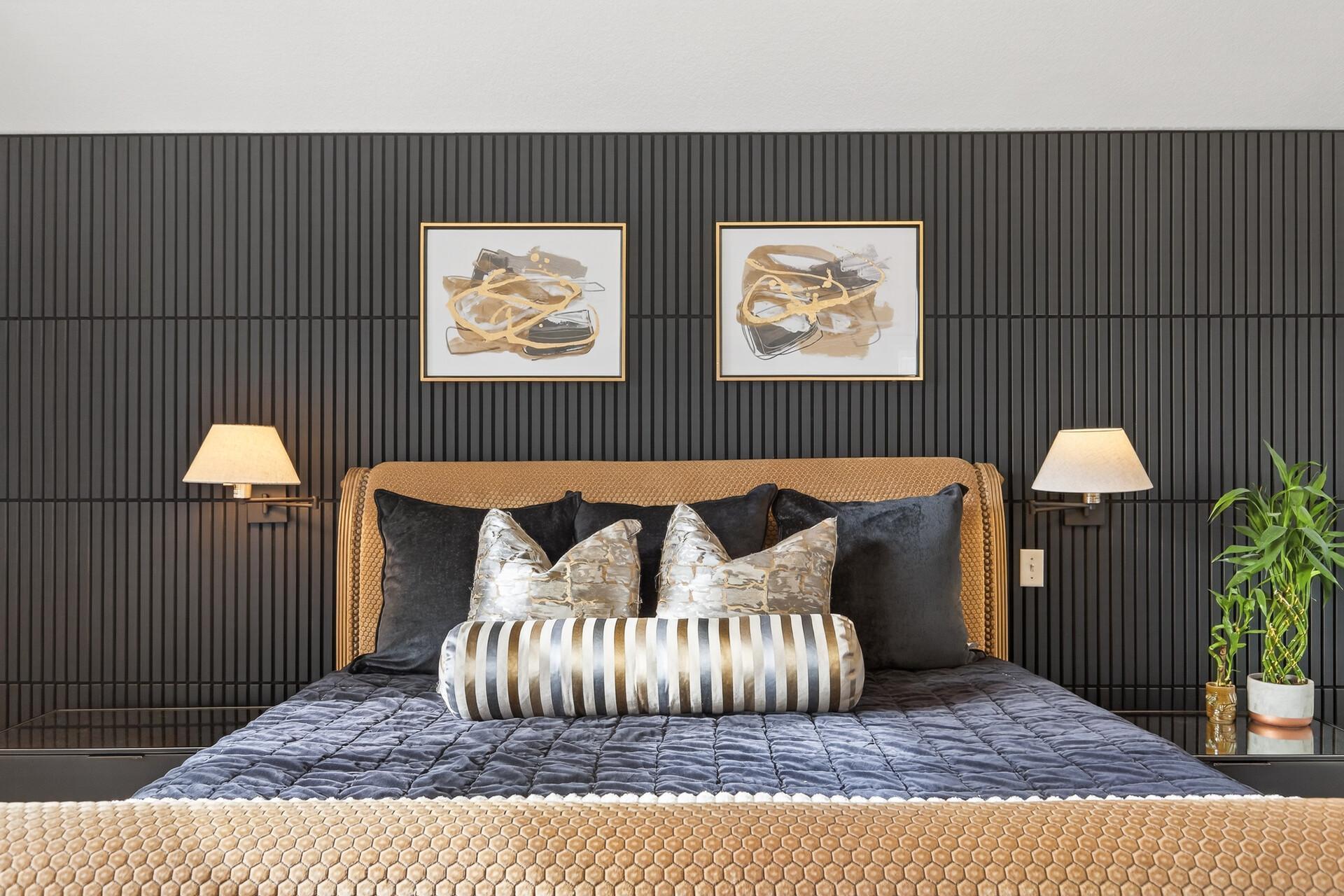 Built-in bedside lamps add a functional, modern touch to the custom accent wall.