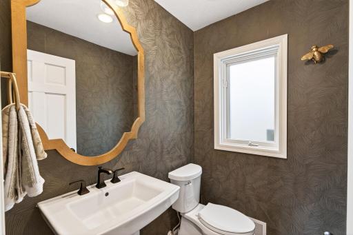 A powder room is privately tucked away between the butlerâs pantry and the mudroom.