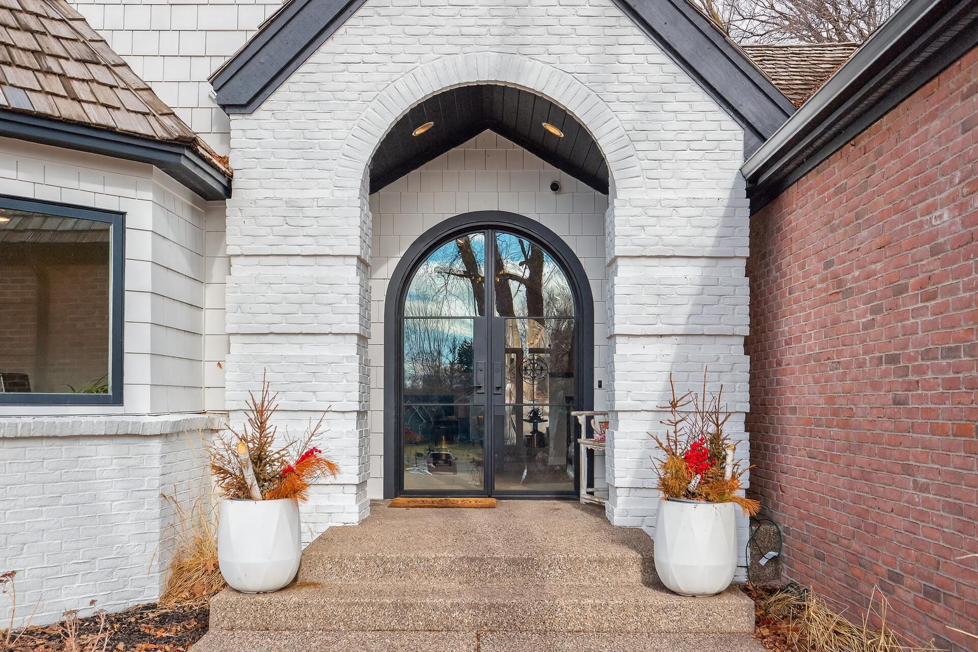The exposed aggregate sidewalk and stairs complements the brick exterior of the home.
