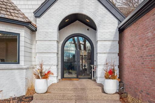 The exposed aggregate sidewalk and stairs complements the brick exterior of the home.