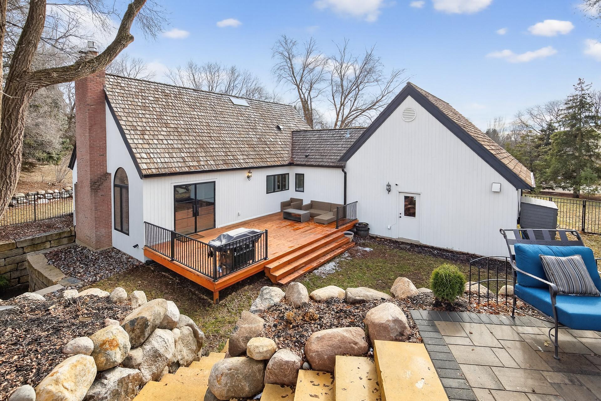 Custom-built stairs are tucked into the boulder wall, creating a seamless connection between the fire pit and the rest of the back yard.
