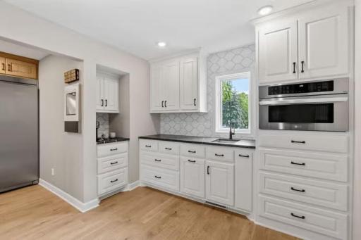 A dedicated coffee station within the butlerâs pantry provides a chic, organized space for your daily caffeine ritual.