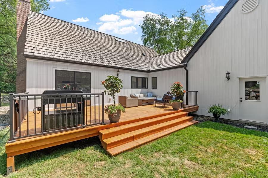 An expansive deck designed for easy flow between the main living spaces and the backyard.