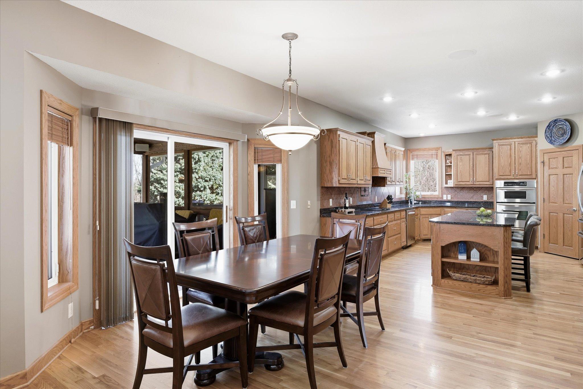 Open kitchen and informal dining space with easy access to the 3-seasons porch, perfect for enjoying morning coffee, grilling, and outdoor gatherings.