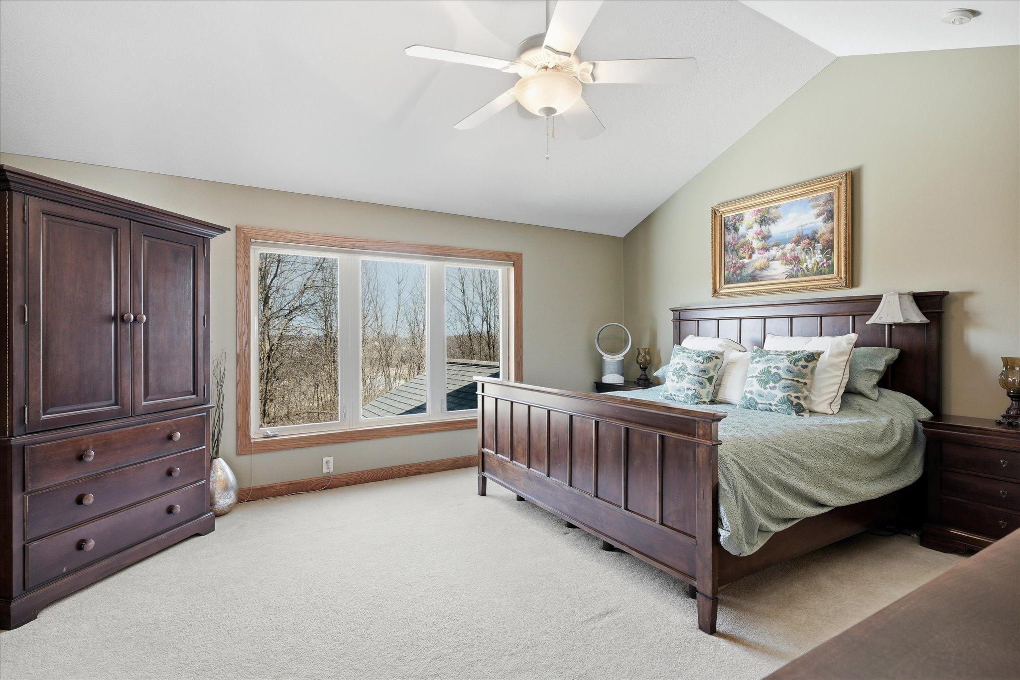 Primary suite with beautiful vaulted ceilings, enhancing the sense of space and natural light for a bright and comfortable retreat.