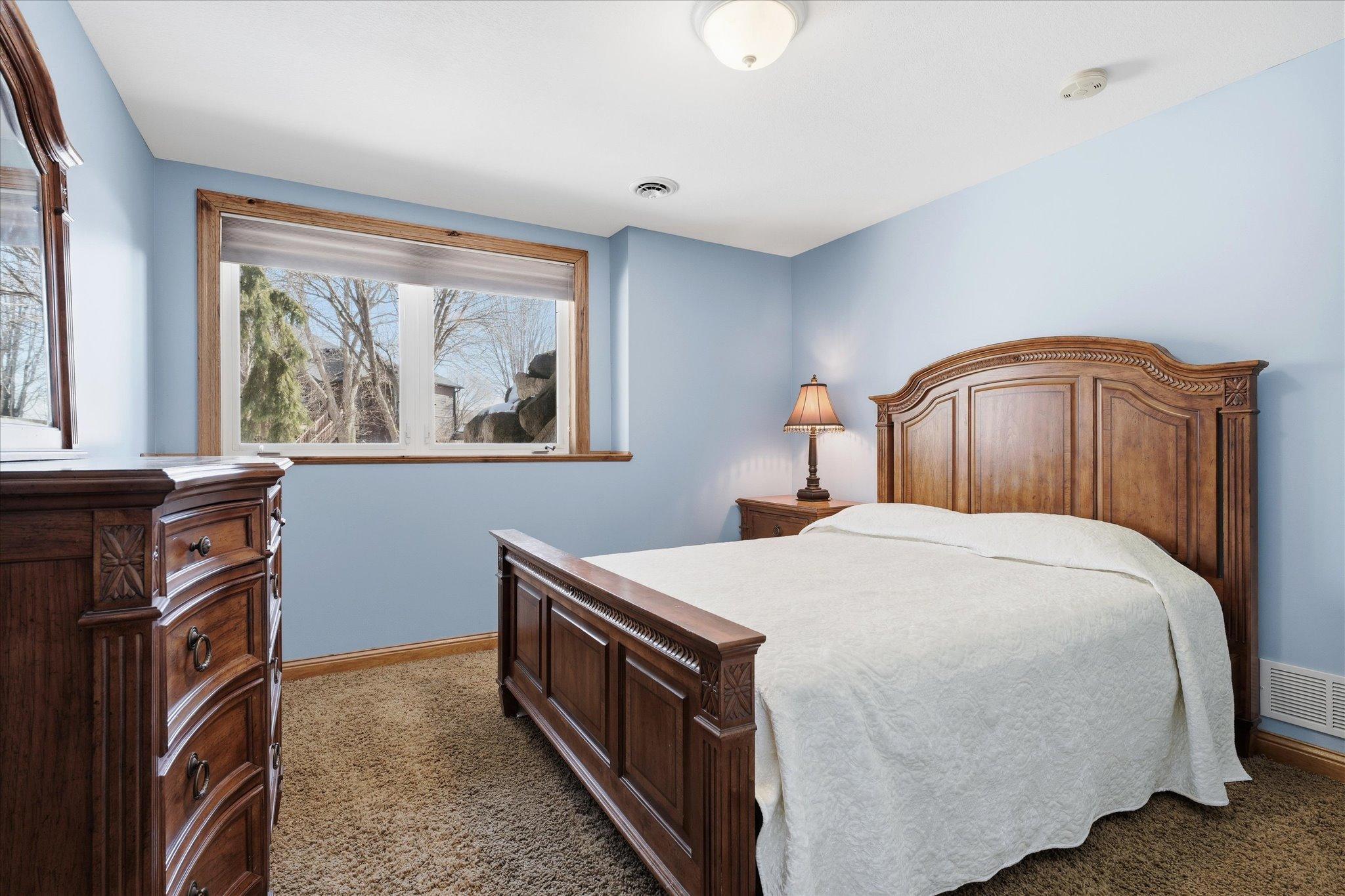 Spacious lower-level fifth bedroom providing flexibility for guests, extended family, or additional living needs.