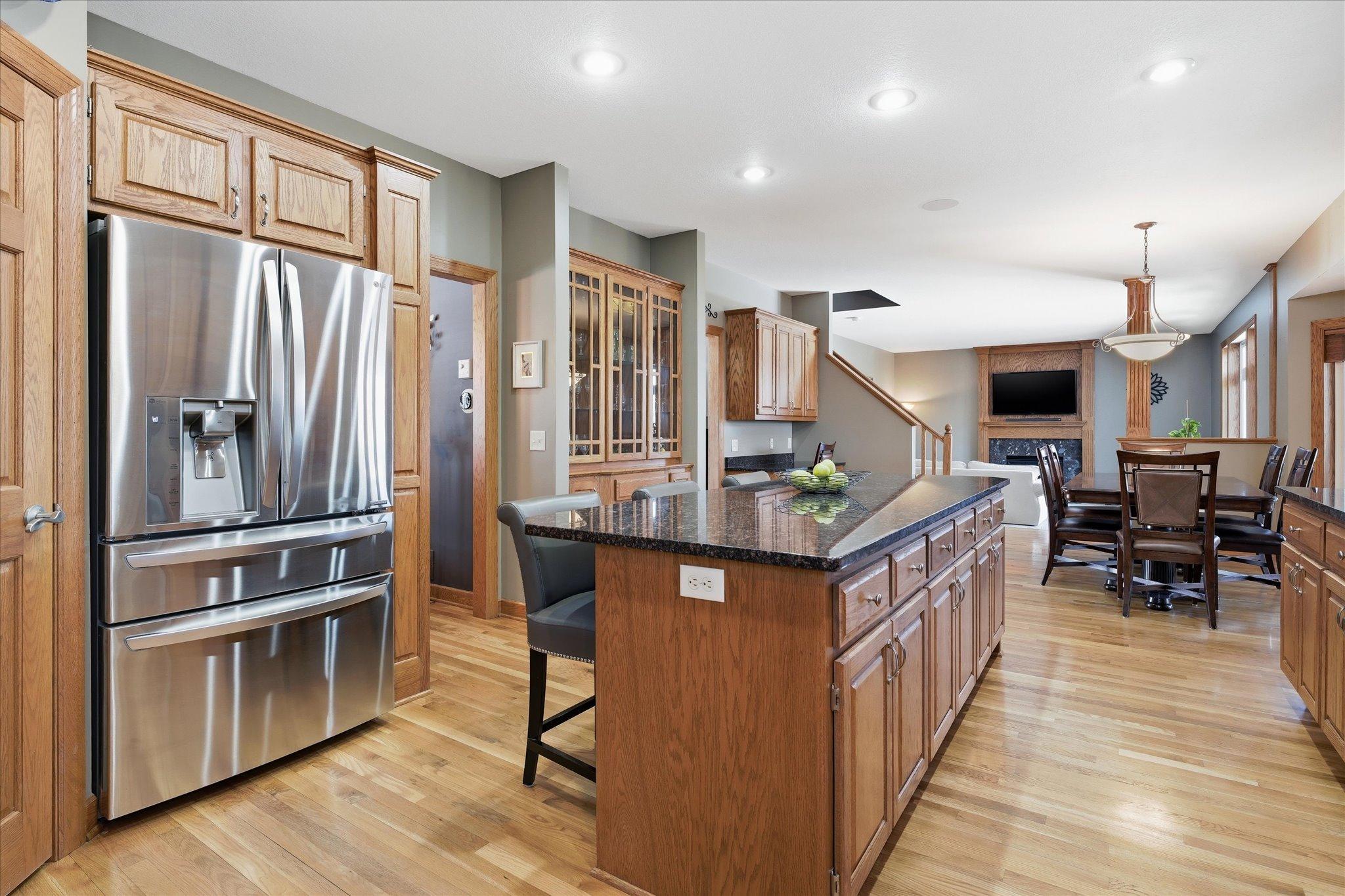 Well-appointed kitchen featuring granite countertops, a large center island, stainless steel appliances.