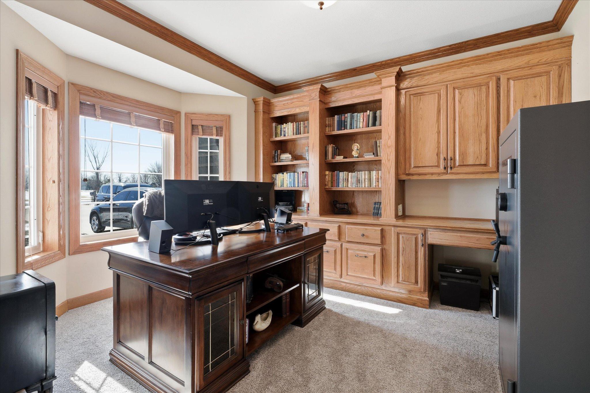 Dedicated executive office with beautiful custom cabinetry, creating a sophisticated and well-appointed space perfect for working from home or managing daily tasks.