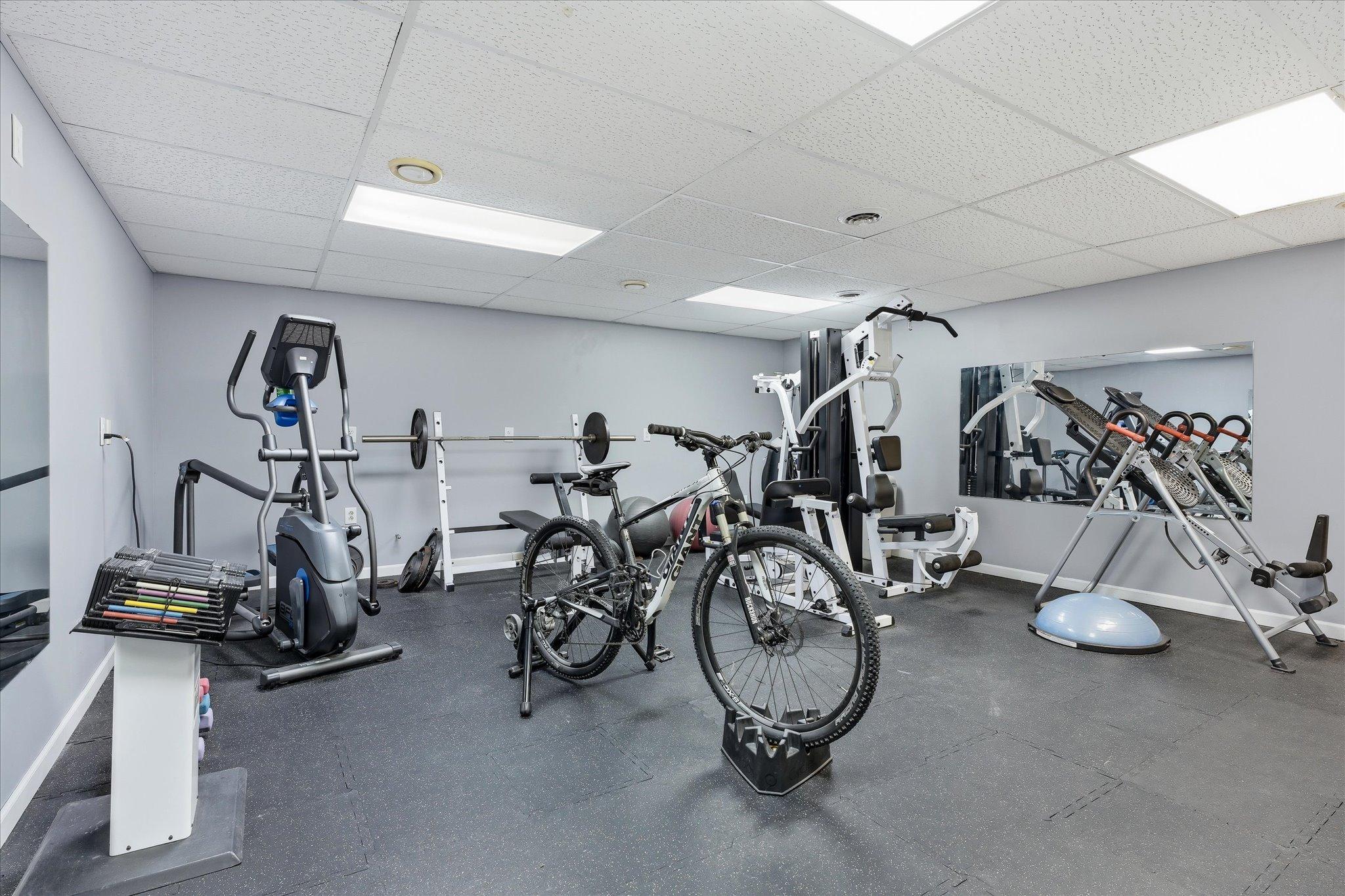 Fully equipped weight room designed for serious training, providing a spacious and private environment for strength workouts and fitness routines.