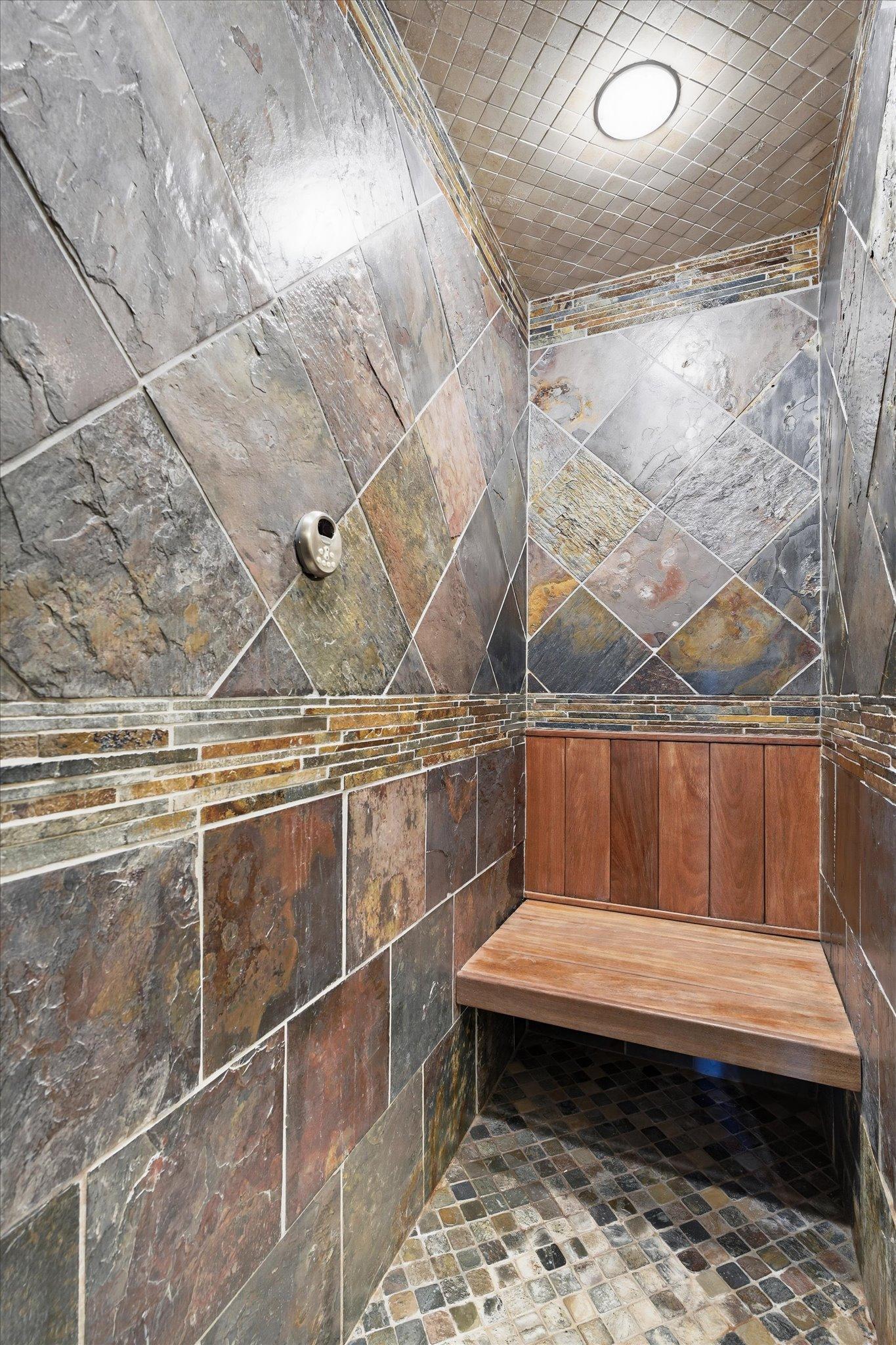 Custom tile shower with bench seating.
