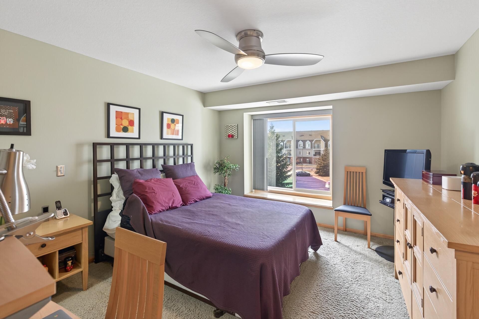 The spacious bedroom features a window seat.