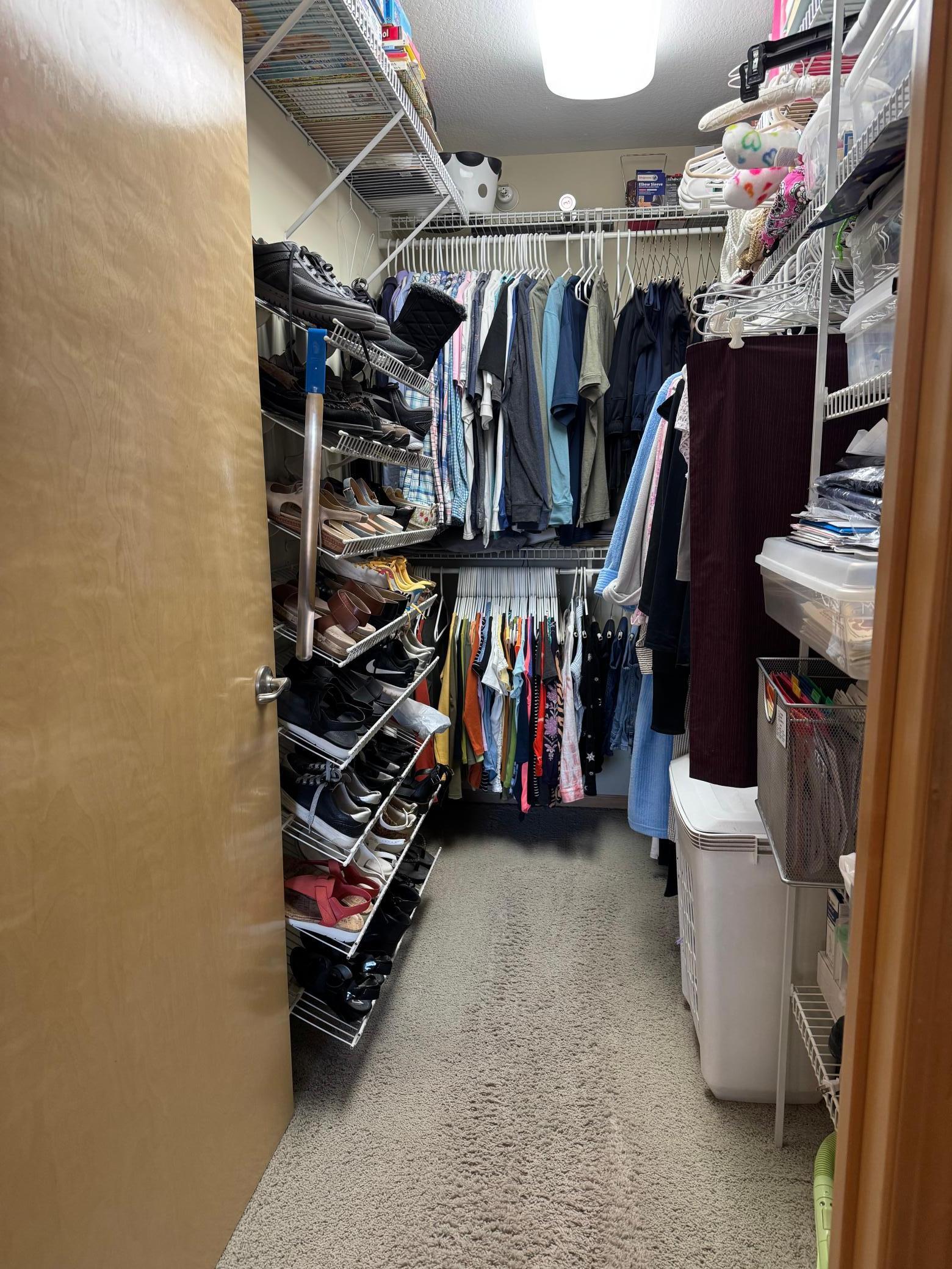 Walk-in closet with a closet organization system.