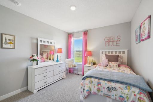 In addition to the primary bedroom, the home's upper level also includes these two additional bedrooms, and another full bathroom just adjacent to each! Photo of model, colors and options will vary.