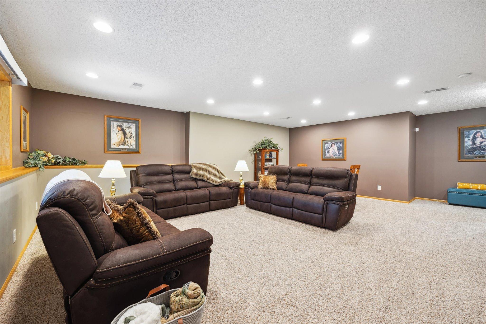 Additional main-level living area features vaulted ceilings, a large arched window, and flexible use as a sitting room or secondary gathering space.