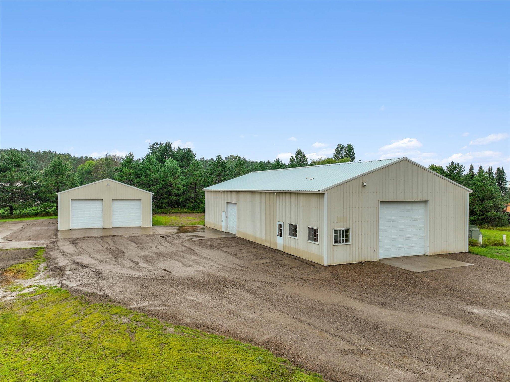 Ground-level view of both outbuildings highlights the flexible space available for storage, workspace, equipment, or business-related use.
