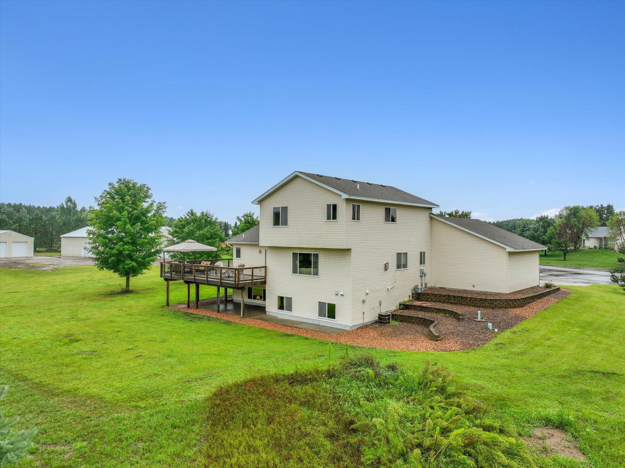 Rear view of the home highlights the open yard space and the functional layout of the property.