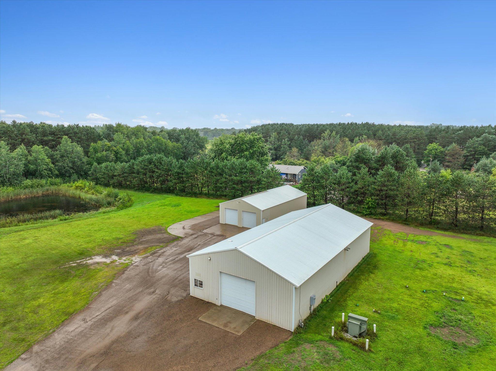 Aerial view of the 40x80 and 30x60 outbuildings shows the scale of the additional heated and insulated functional space on the property.
