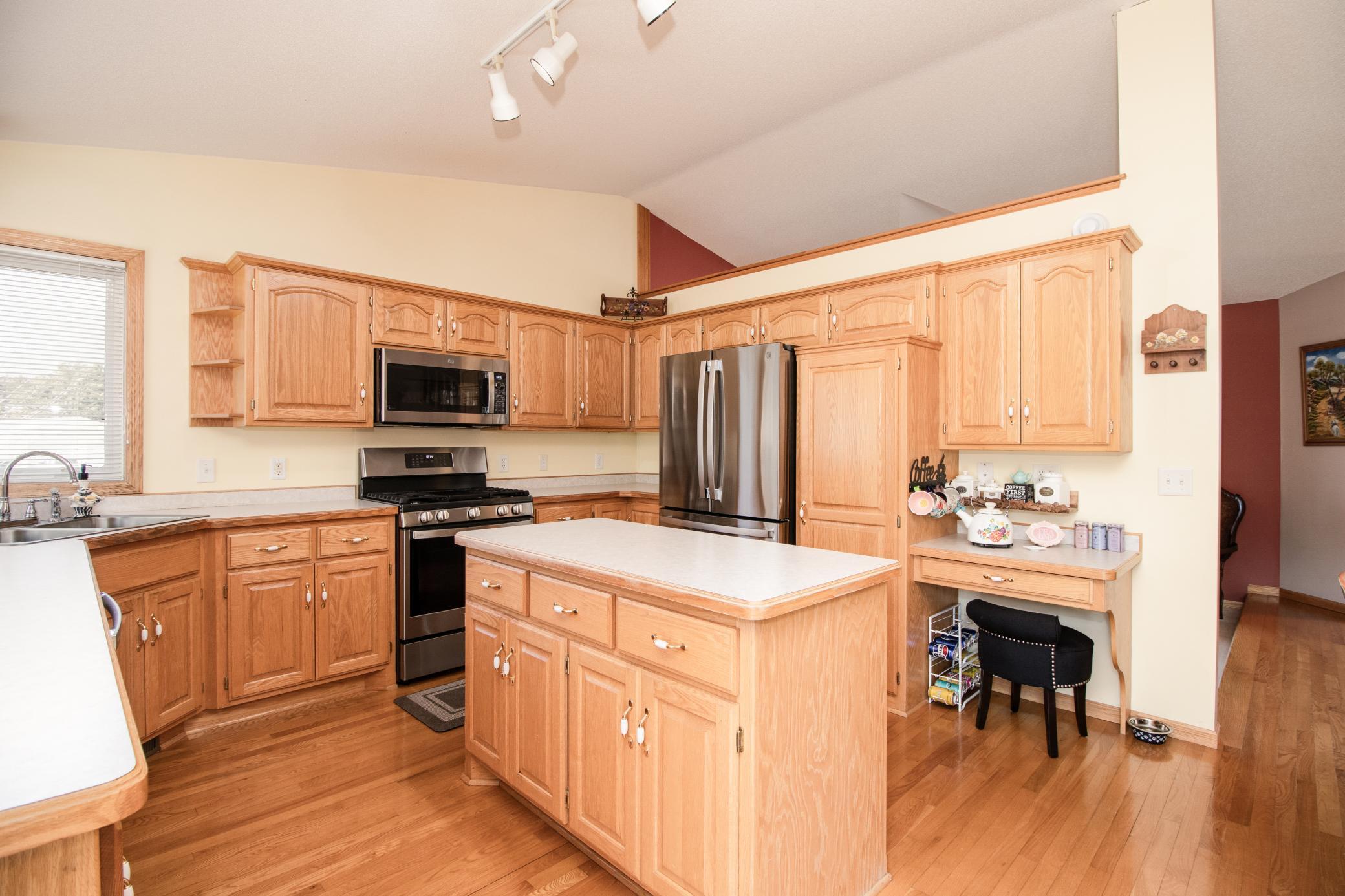 Kitchen features abundant cabinetry, center island workspace, and updated stainless steel appliances installed in 2025.