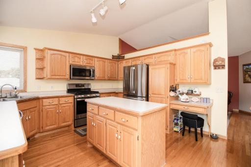 Kitchen features abundant cabinetry, center island workspace, and updated stainless steel appliances installed in 2025.