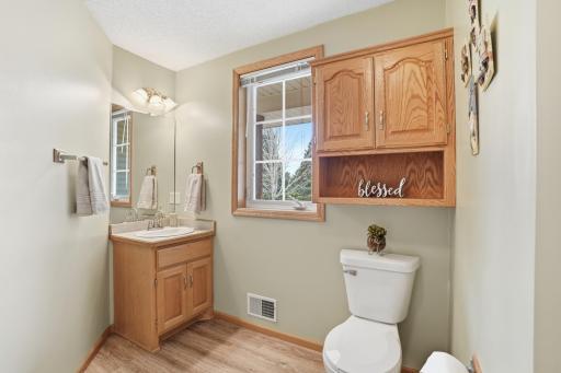 Convenient main-level half bath with window for natural light and tasteful finishes.