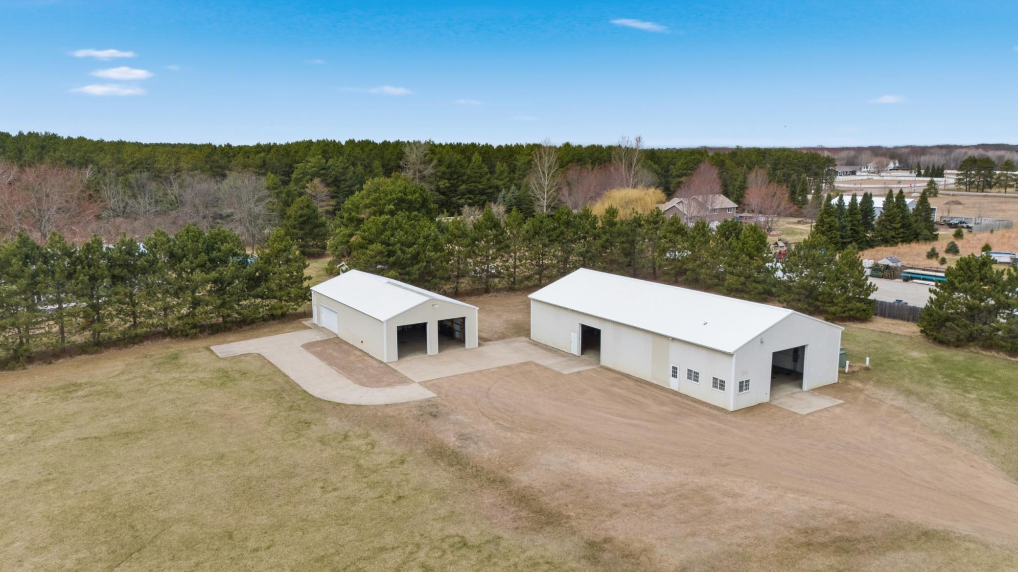 Elevated aerial perspective showcases both outbuildings positioned for convenient access and functional separation.