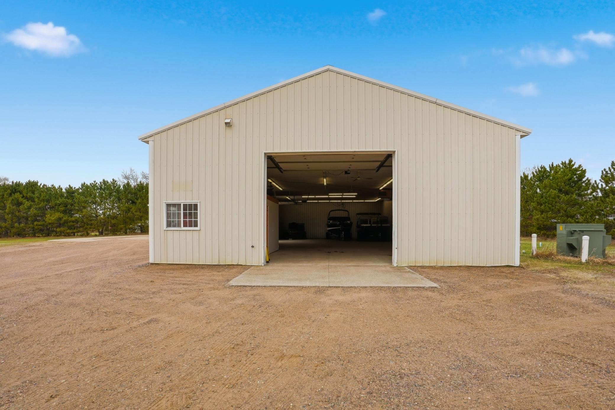 Main heated shop building features oversized overhead access, ideal for RVs, boats, equipment, or business use.