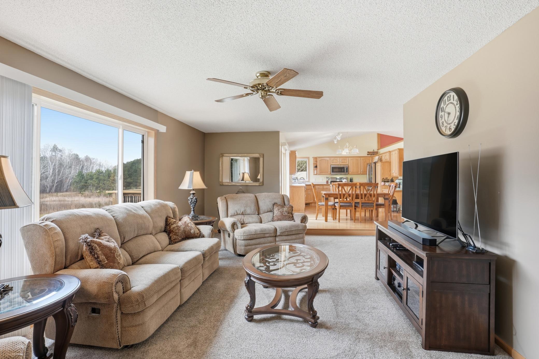 Alternate family room view showcasing the open-concept layout connecting living, dining, and kitchen spaces.