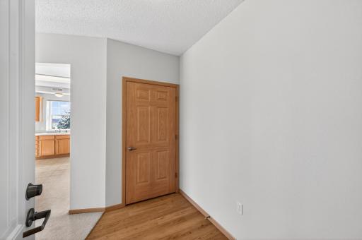 Front entry with hard surface flooring and coat closet