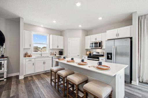 This home showcase a stunning backsplash complemented by elegant hardware. *Photos are of a previously staged model*